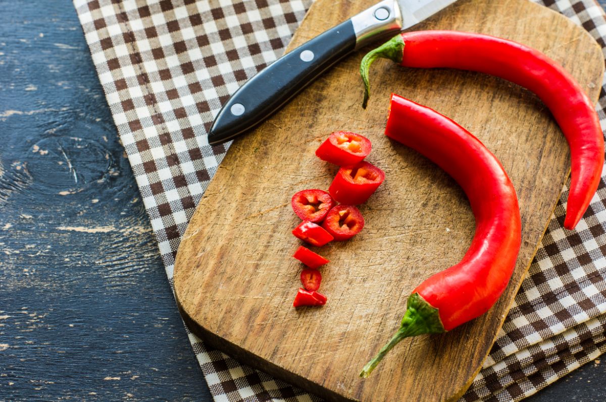 Red peppers being cut to make Giardiniera