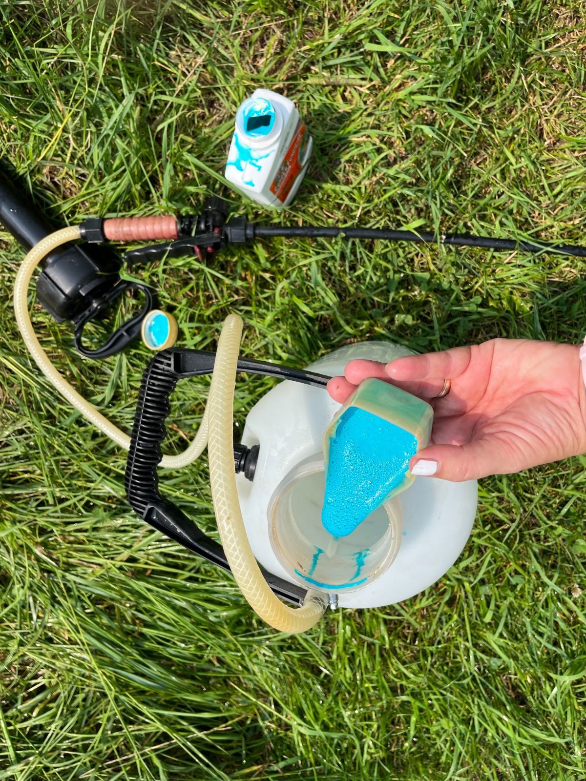 A gardener diluting an organic spray concentrate