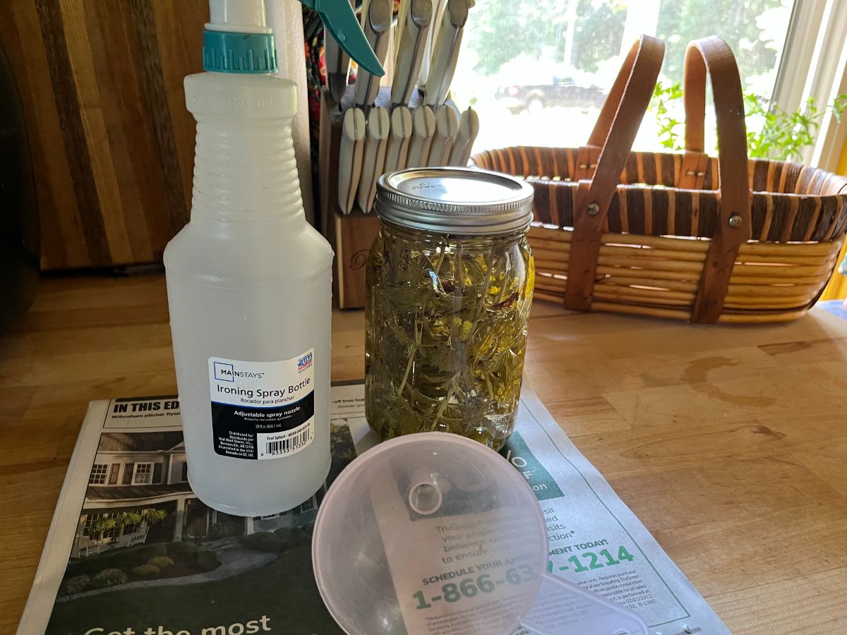 A spray bottle next to mint infused vinegar