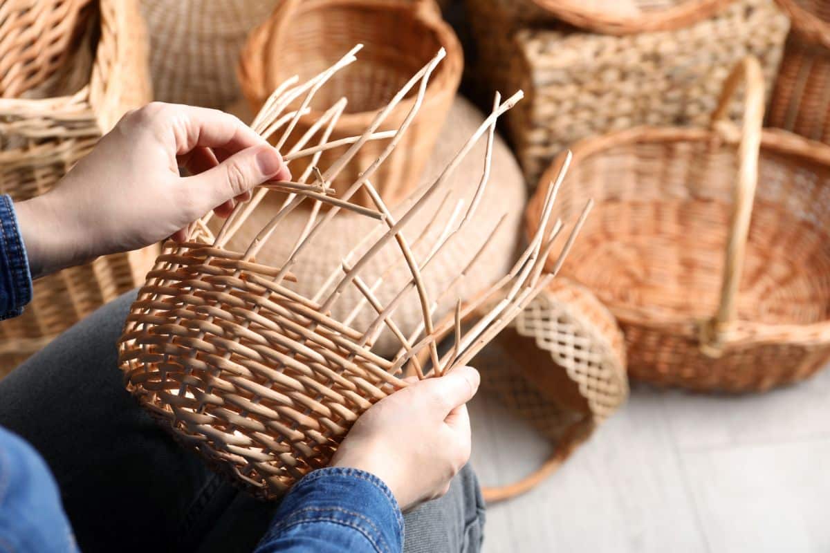 A person weaving a handmade basket