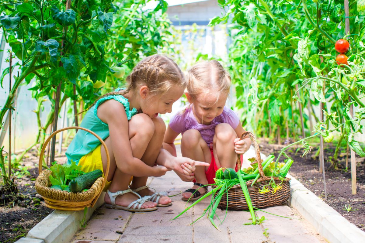 Two girls play I Spy in the garden