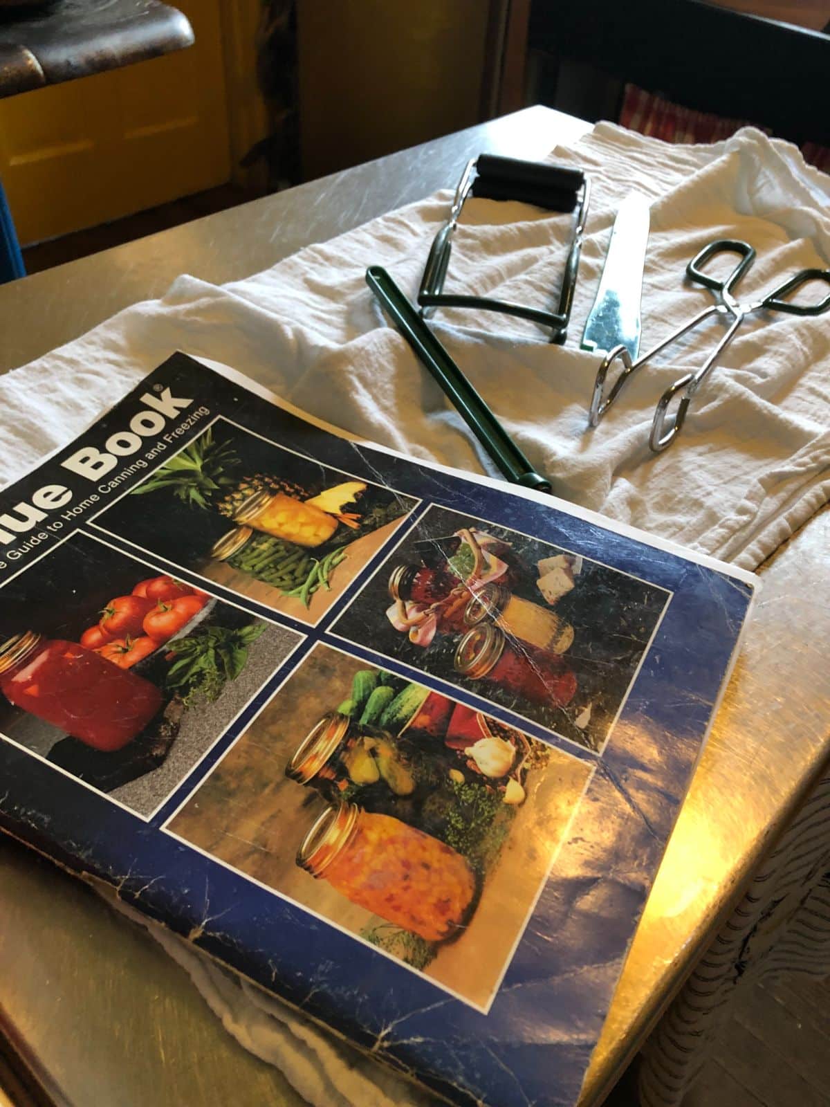 Basic canning utensils and a canning book
