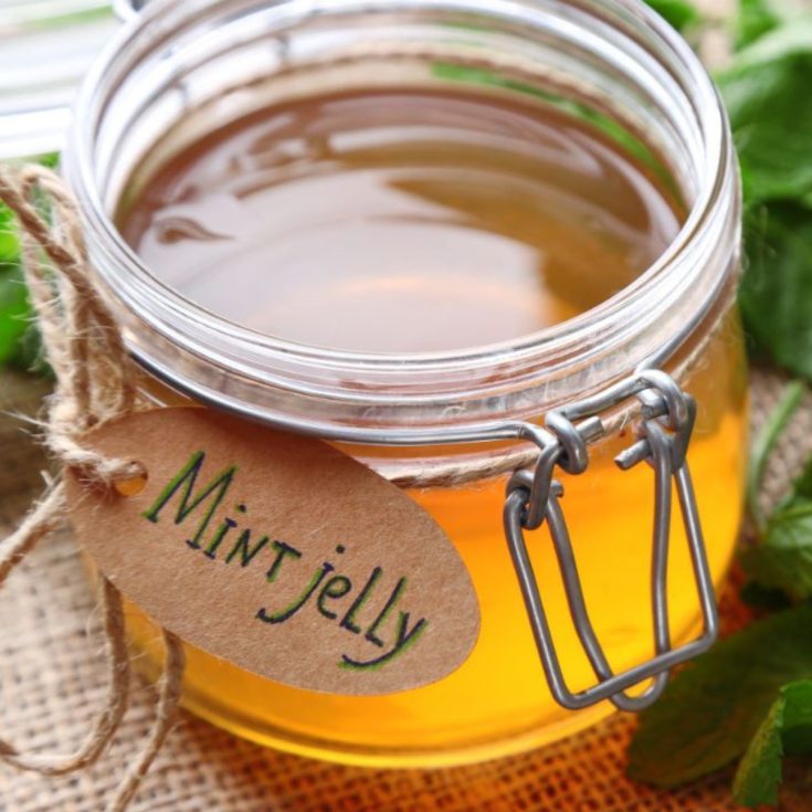 A glass jar of mint jelly.