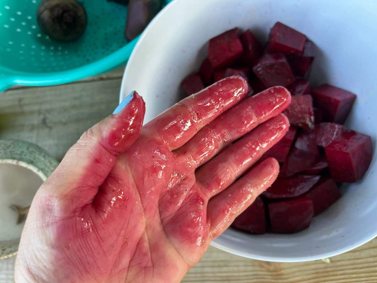 An oily red hand from mixing beets with seasonings