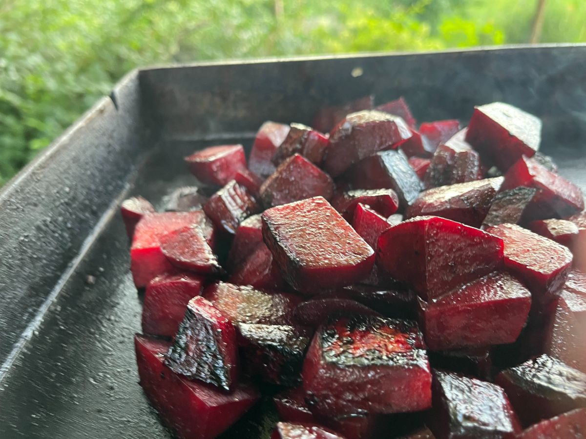 Lightly blacked roasted beets on a flat grill