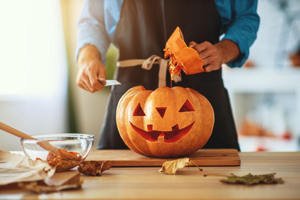 A person carving a pumpkin