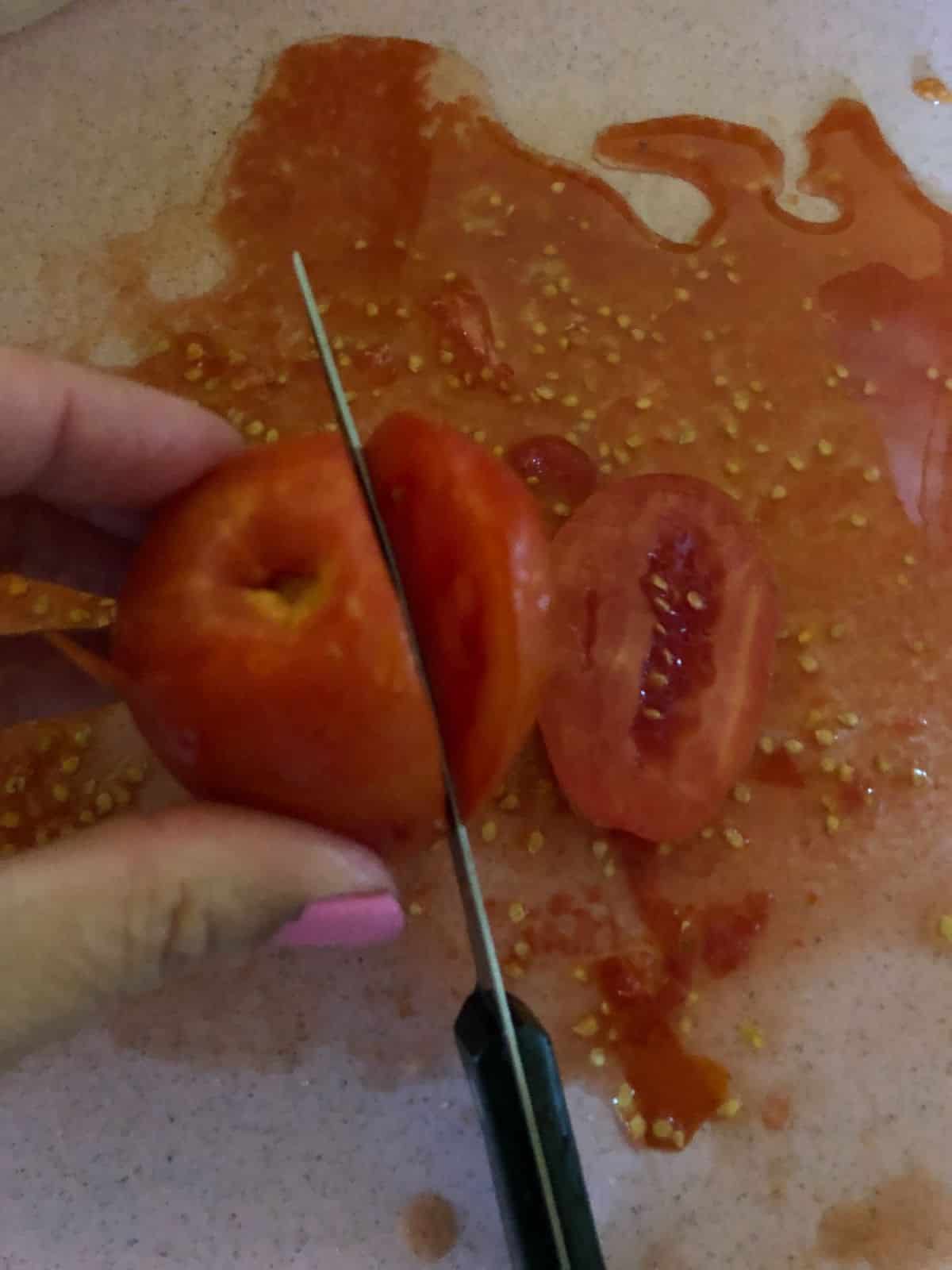 Tomatoes being sliced to dehydrate