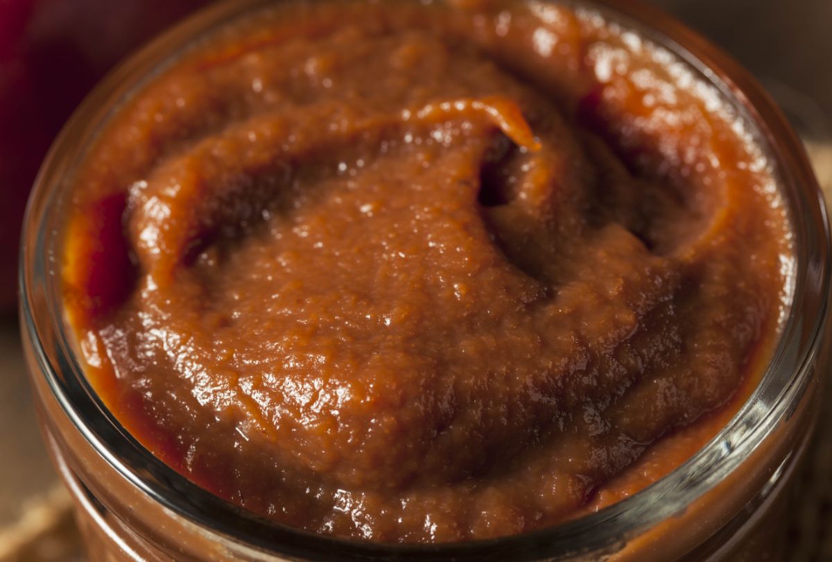 A jar of thick brown apple butter