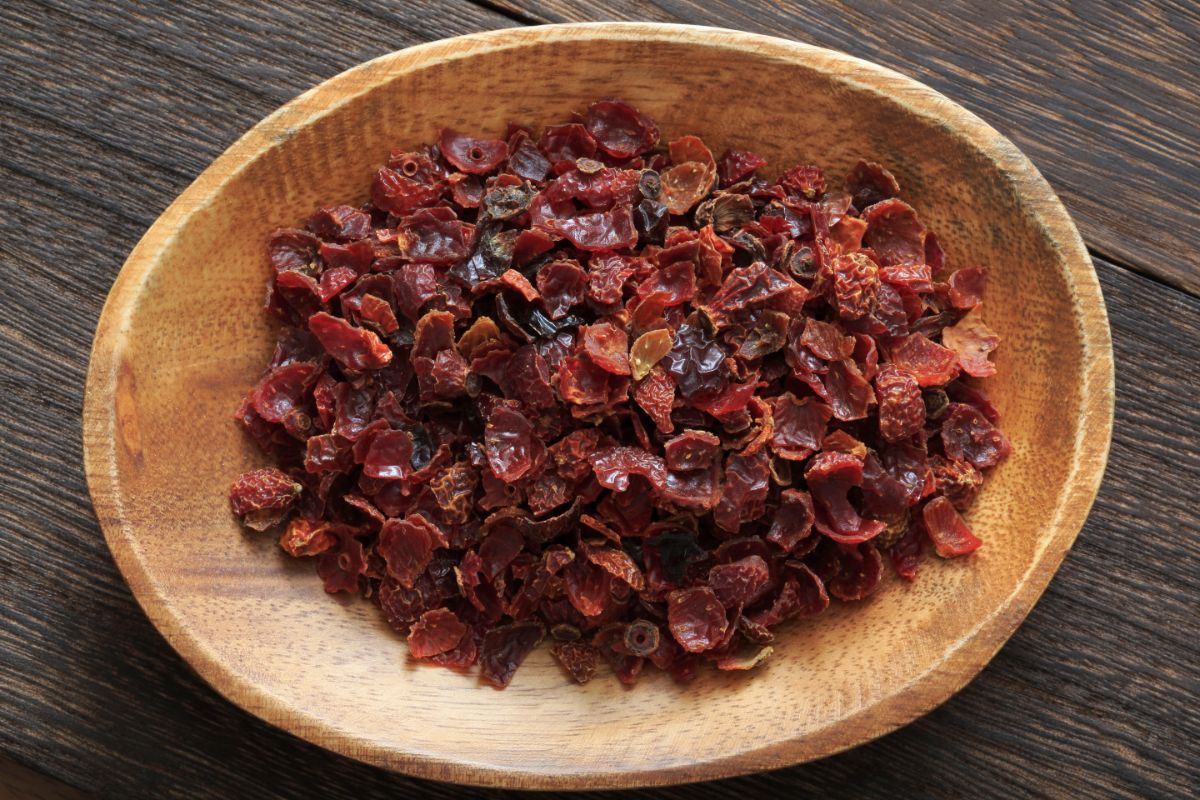 Dried rose hips in a wooden bowl