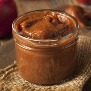 Homemade Sweet Apple Butter with Cinnamon in a glass jar.