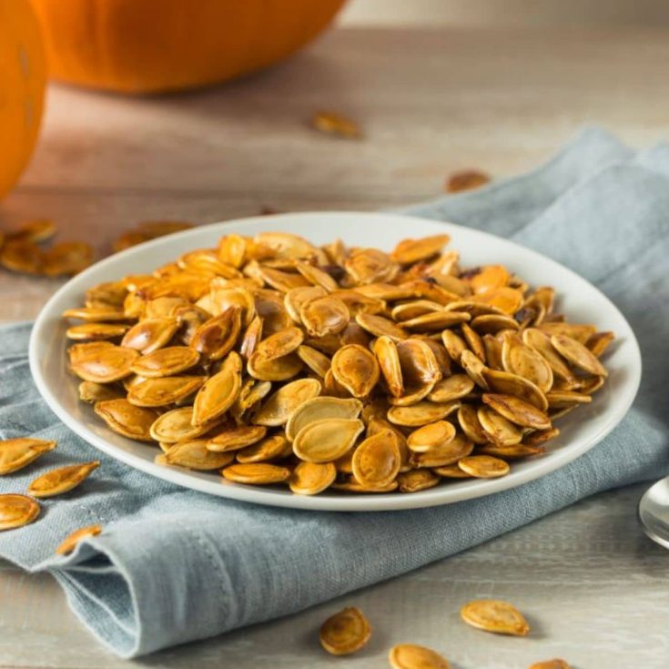 Delicious roasted pumpkin seeds on a plate.