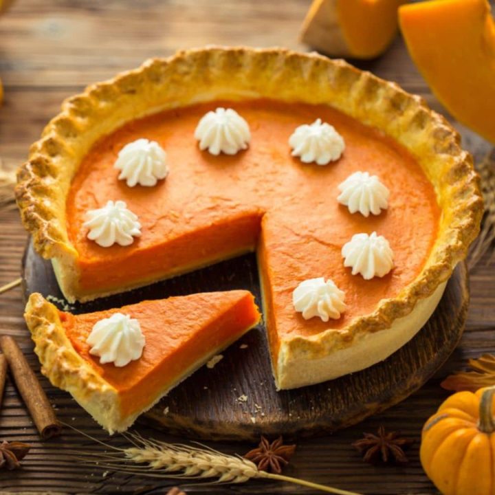 Fresh homemade pumpkin pie on the wooden table.