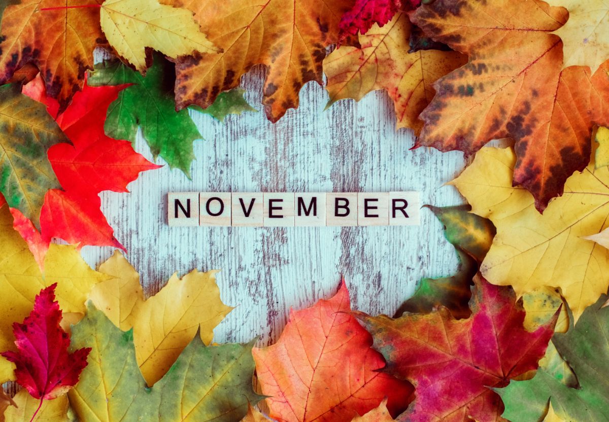 November spelled with letter tiles in the middle of a ring of leaves