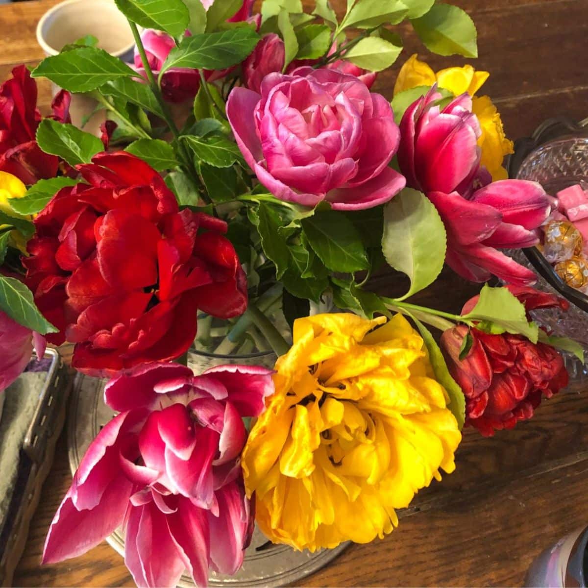 A colorful bouquet of fall flowers on a table.