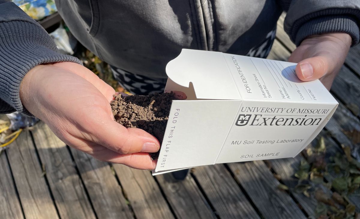 Soil being put into a box for testing