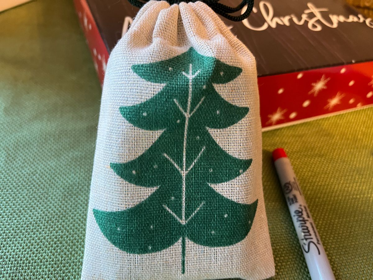 A small gift wrapped in a fabric bag