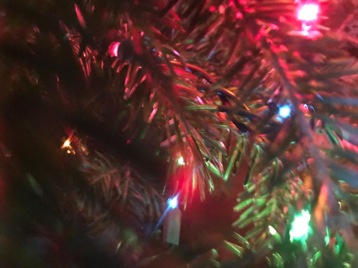 A close up of lights on a Christmas tree