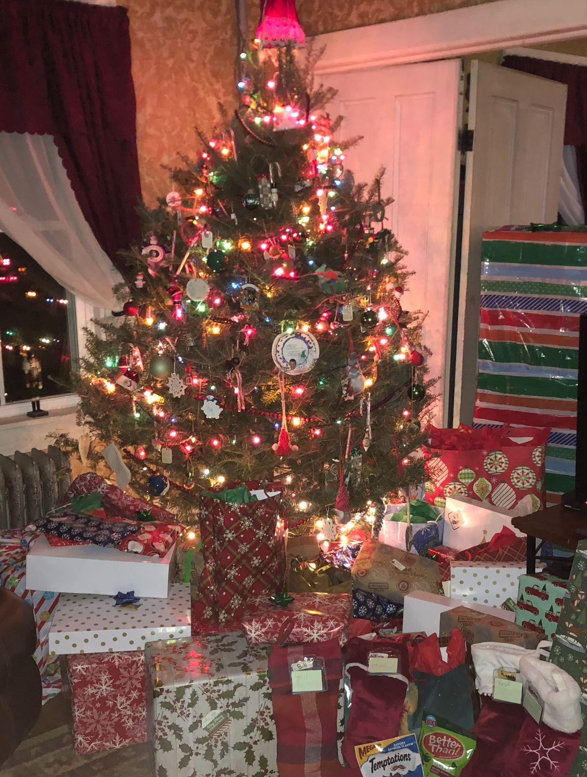 A Christmas tree surrounded by gifts
