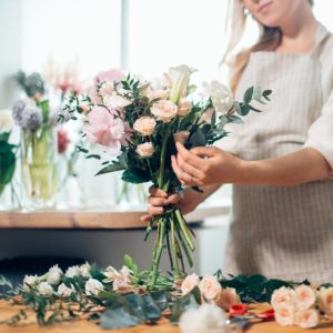A female florist making a beautiful bouquet.