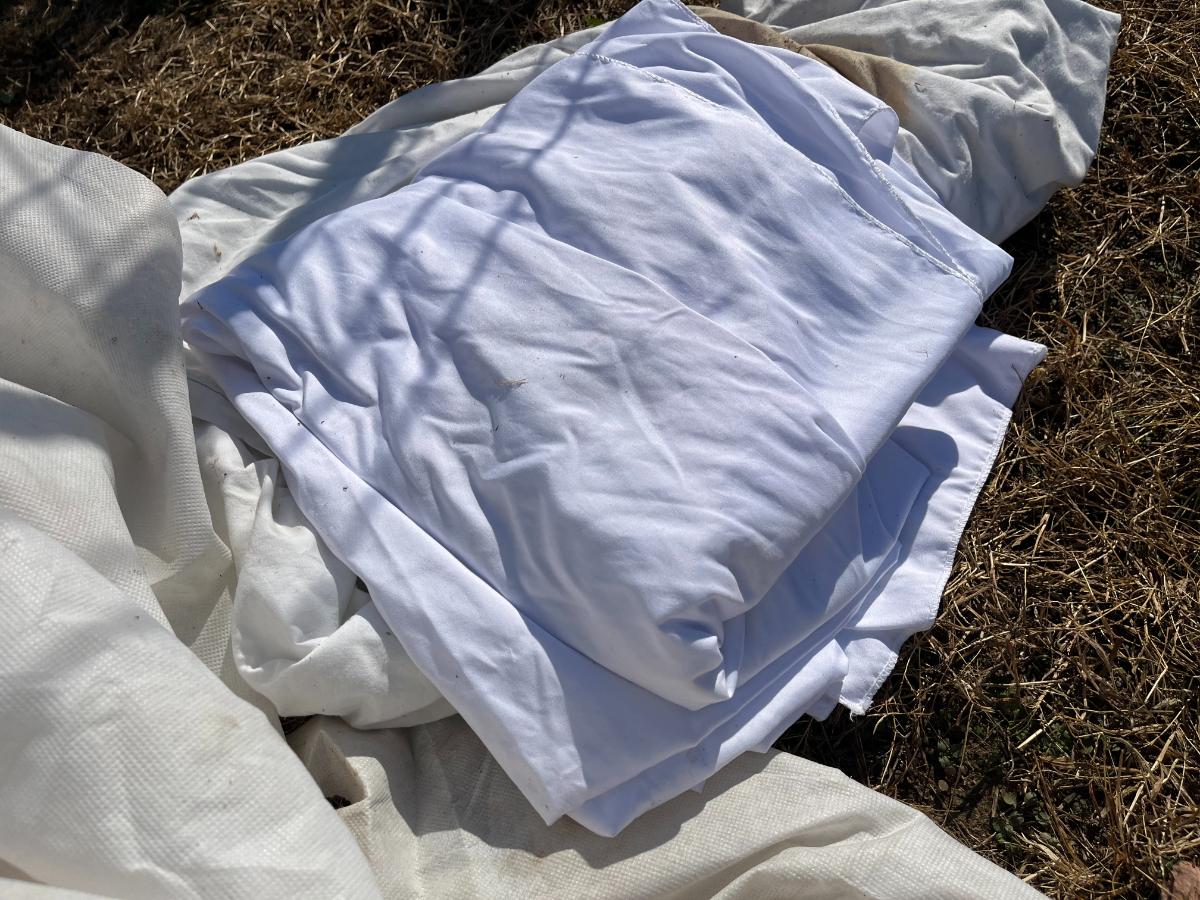 A pile of old sheets and tablecloths used for frost fabric