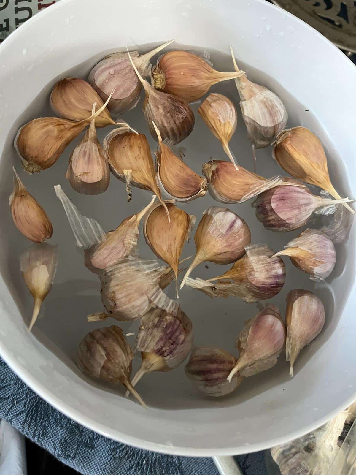 Soaking garlic cloves for peeling.