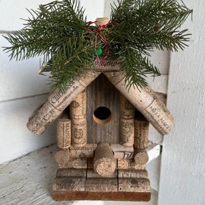 A winter birdhouse made from wine bottle caps.