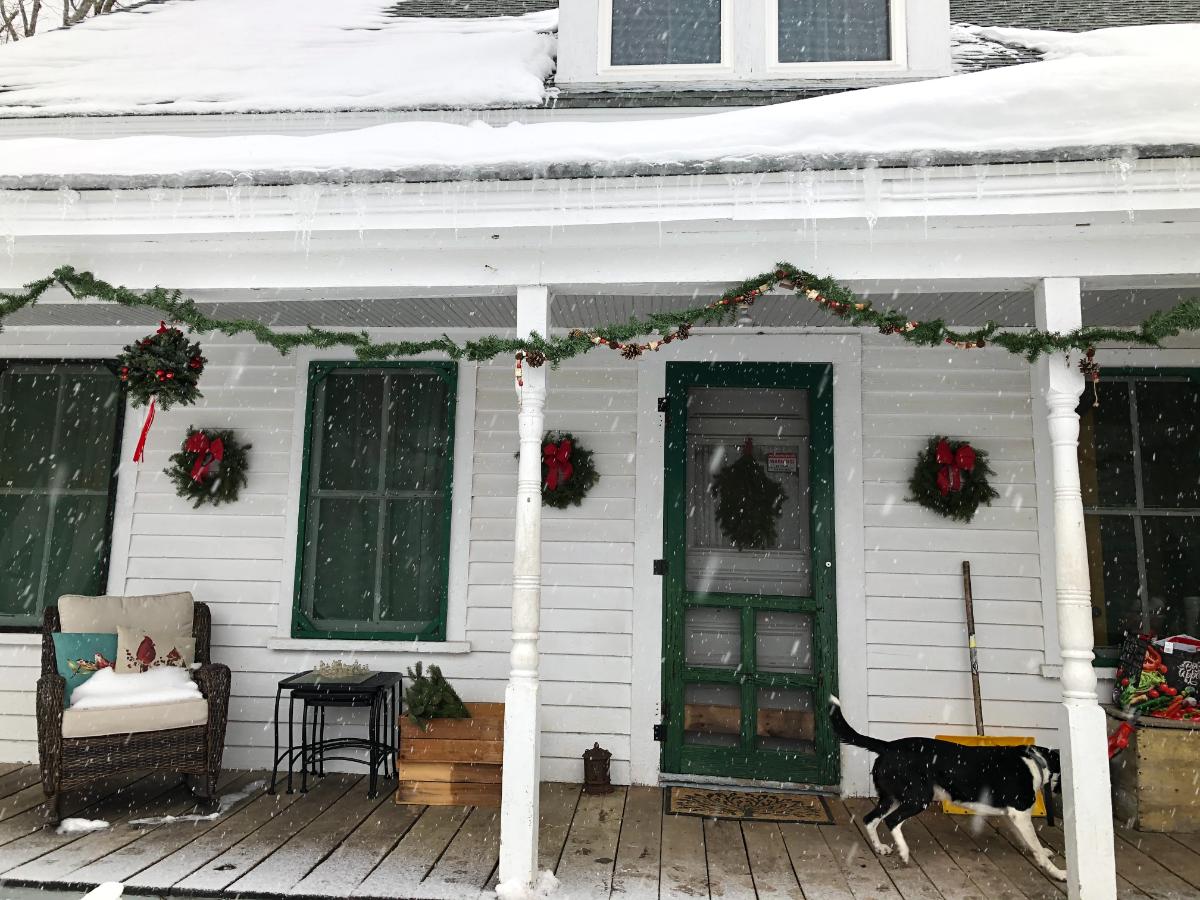 Porch decorated for Christmas with natural materials