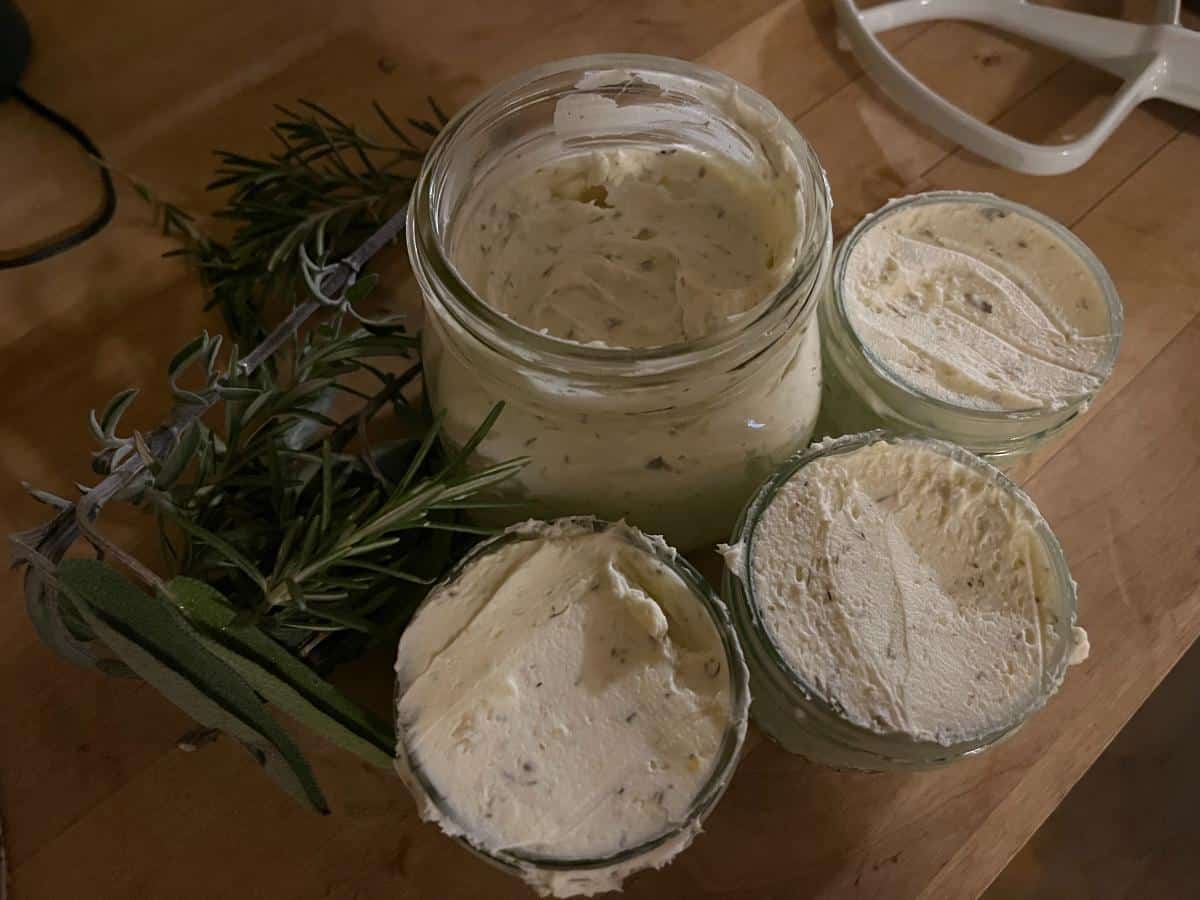 Jars of homemade garlic herb cream cheese spread