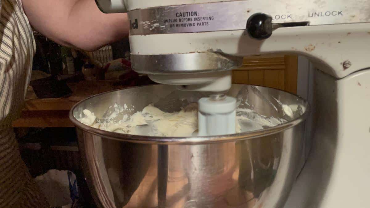 Making garlic cream cheese herb spread in a mixer