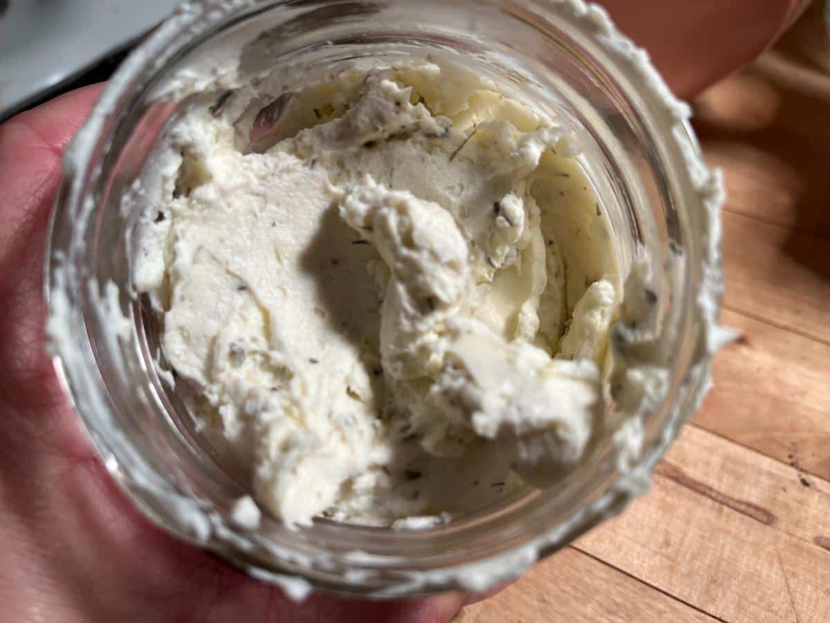 Jars of homemade garlic herb cream cheese spread