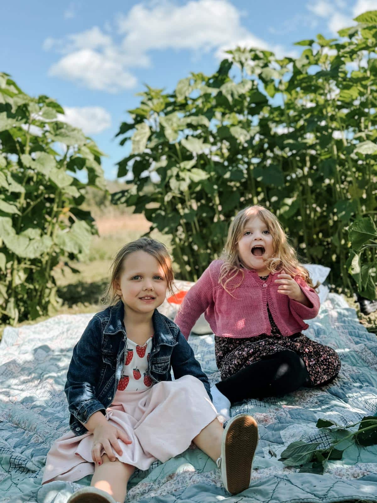 Girls enjoying a comfy sunflower house for a picnic