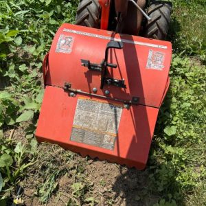 Using a rototiller to get rid of the weeds.
